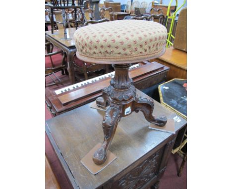 A XIX Century Walnut Stool, having poker work carving to tripod legs, circular fabric top, swivel action.