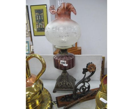 An Early XX Century Iron Based Oil Lamp, with Amethyst glass well and frilled wavy edged shade.