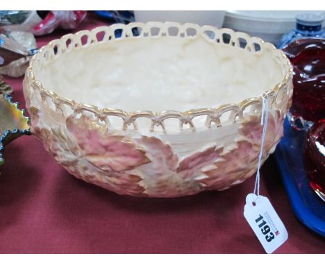 A Royal Worcester Porcelain Circular Bowl, with a pierced rim, blush ivory basket work, ground moulded with foliage printed m