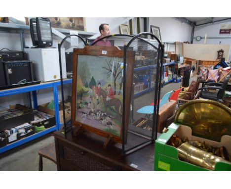 An oak cased fire screen depicting a hunting scene; together with a three fold spark guard