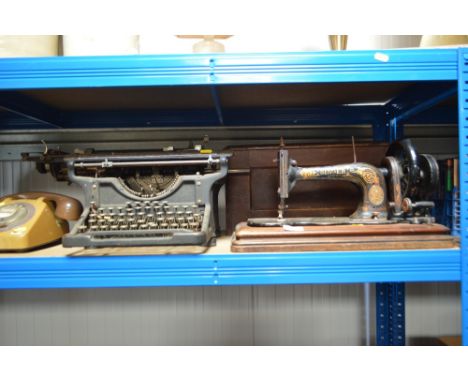 A Singer hand sewing machine in carrying case; together with an Underwood typewriter