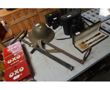 A World War II stirrup pump together with a Civil Defence helmet