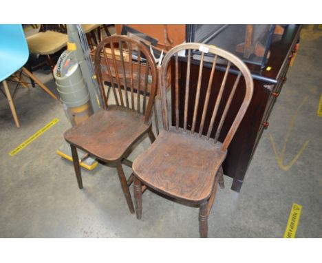 A pair of elm seated stick back dining chairs