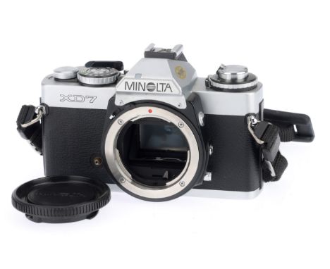 A Minolta XD7 35mm SLR Camera Body, silver, serial number 2246085, body VG, with batteries inserted the shutter works on manu