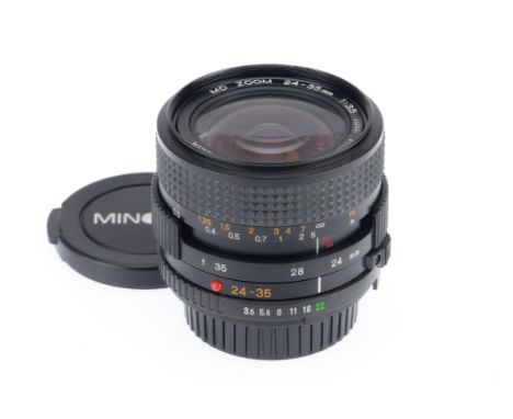 A Minolta MD Zoom f/3.5 24-35mm Lens, black, serial number 1013237,barrel VG, optics F, internal spotting and haze, with caps