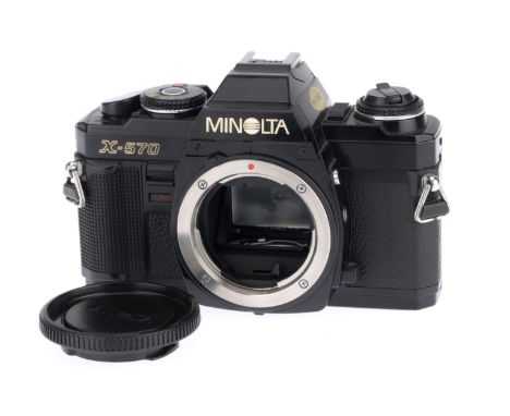 A Minolta X-570 35mm SLR Camera Body, black, serial number 9004733, body VG, with batteries inserted the shutter works at all