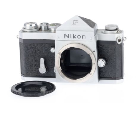 A Nikon F 35mm Camera Body, silver, serial number 6750583, body G, light usage marks to bottom plate, shutter works, focussin