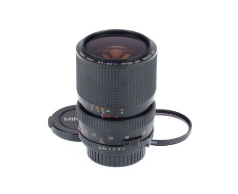 A Minolta MD Zoom f/3.5-4.5 28-85mm Lens, black, serial number 1028959, barrel VG, optics VG, with caps.