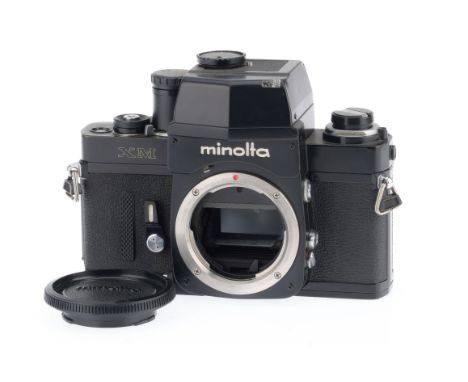 A Minolta XM 35mm SLR Camera Body, black, serial number 2120719, body VG, light brassing to edges, shutter works, battery tes