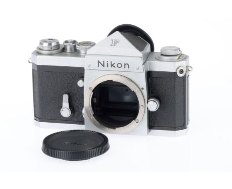 A Nikon F 35mm Camera Body, silver, serial number 6715341, body G, usage marks to bottom plate, shutter works but speeds long