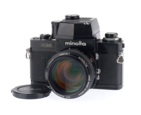 A Minolta XM 35mm SLR Camera and f/1.2 Lens, black, serial number 2121028, body VG, very small dent to right hand end of top 