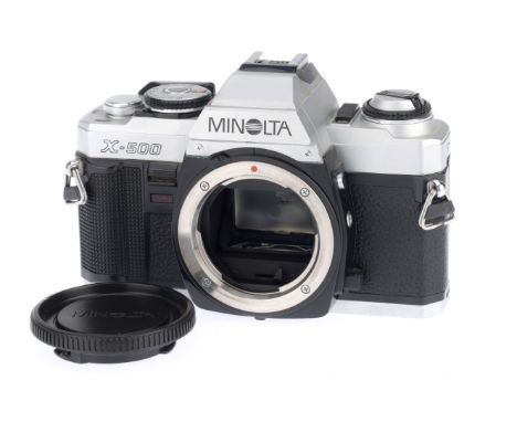 A Minolta X-500 35mm SLR Camera Body, silver, serial number 6123844, body VG, with batteries inserted the shutter works on ma