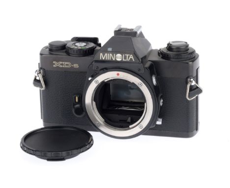 A Minolta XD-s 35mm SLR Camera Body, black, serial number 3088180, body VG, with batteries inserted the shutter works and the