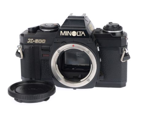 A Minolta X-500 35mm SLR Camera Body, black, serial number 6065940, body VG, with batteries inserted the shutter works and th