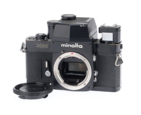 A Minolta XM 35mm SLR Camera Body, black, serial number 2127252, body VG, shutter works, battery tested.