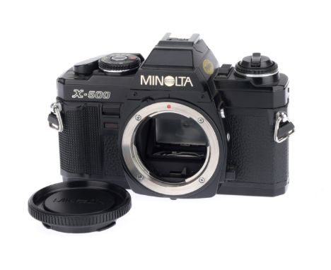 A Minolta X-500 35mm SLR Camera Body, black, serial number 6084438, body VG, with batteries inserted the shutter works and th