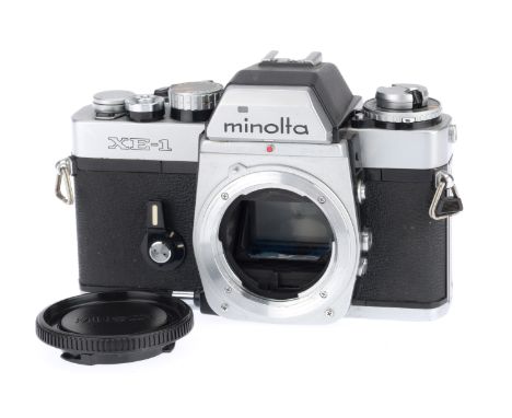 A Minolta XE-1 35mm SLR Camera Body, silver, body G, with batteries inserted the shutter works only occasionally and the mete