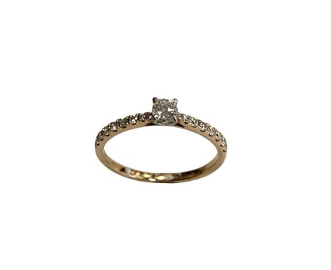 A 9ct solitaire diamond ring, set with diamond shoulders, approximately 0.3ct.