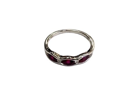 An 18ct white gold ruby and diamond band ring