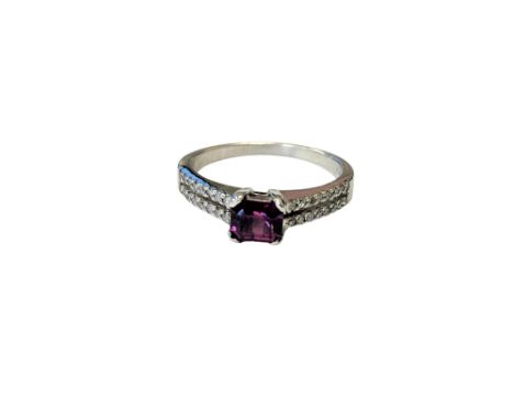 An 18ct white gold ruby and diamond ring, size  M.