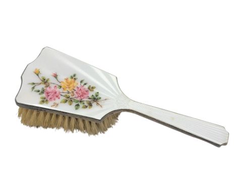 A silver and floral enamel dressing table brush