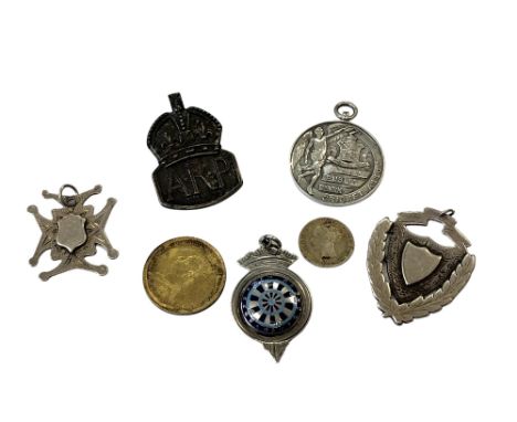 Three silver fobs, two silver and enamel coins and a silver Air Raid Precautions badge 