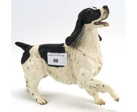 A Beswick ceramic figure depicting a joyful Spaniel, 18cm high Condition Report: Very minor wear to the black ears. Good cond