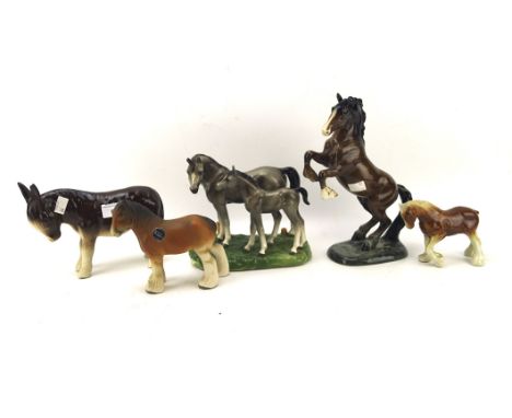 Four ceramic horses and a donkey, including a Beswick model of a rearing horse no.1041, height of tallest 27cm