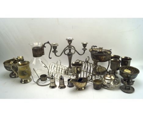 An assortment of 19th and 20th century silver plate and metalware, including a candlestick, a set of four goblets, two toast 