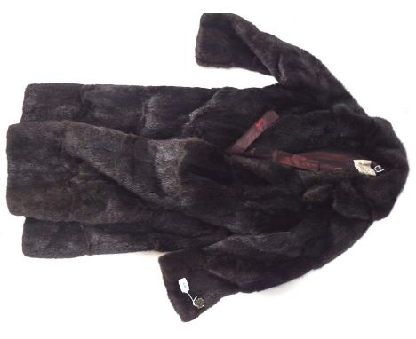 A vintage black fur coat by M &amp; Michaels Furs of Bristol, lined in red, length circa 120cm