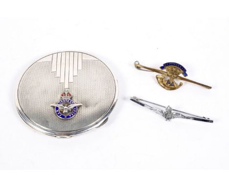 A silver RAF compact and two military pins, the compact of circular form, hallmarked Birmingham 1940, 51g, one of the two pin