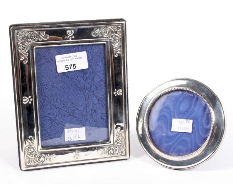 Two contemporary silver mounted photo frames, the largest of rectangular form, the smaller circular, larger being hallmarked 