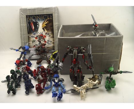 A collection of Lego bionicles, together with an instruction manual