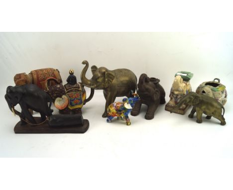 A collection of assorted figures of elephants, to include a large brass example. ceramic, wooden and more