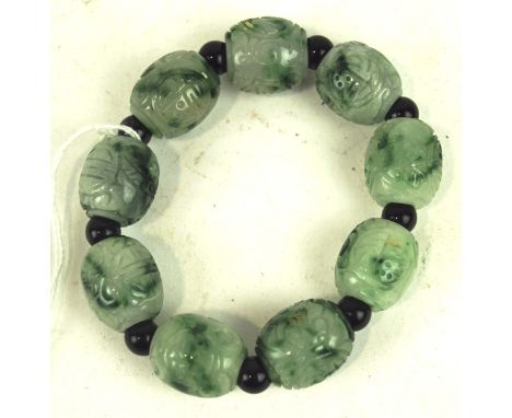 A vintage carved jade bead bracelet, interspersed between smaller beads