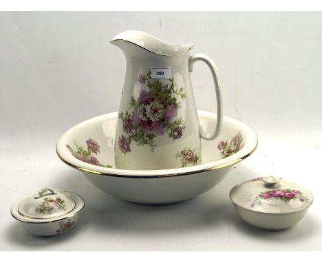 An Empire Works Stoke on Trent wash jug and basin set decorated with roses on a cream ground, including jug, basin, lidded so