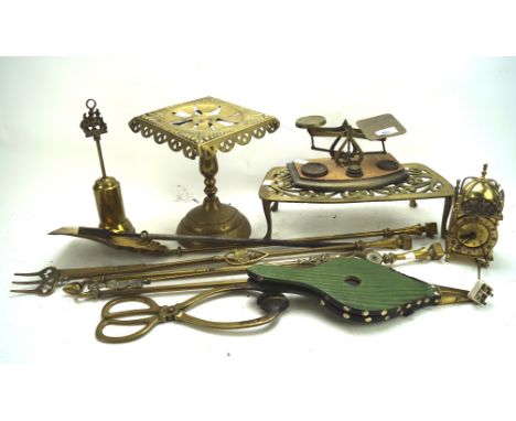A collection of 19th and 20th century brassware, including fire tools, a set of scales, a pair of bellows, clock and more