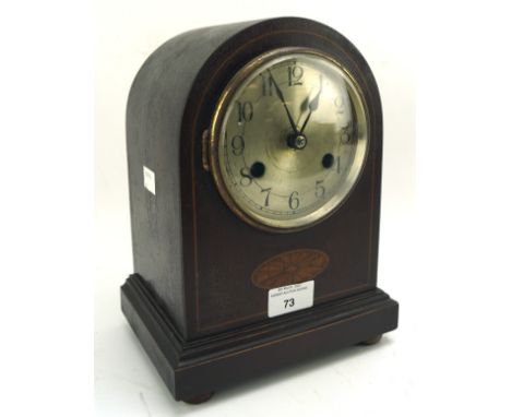 A 20th century stained wood dome topped mantle clock, the silvered dial with Arabic numerals denoting hours, 25.5cm high