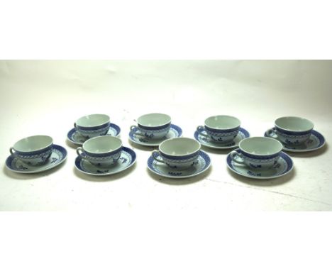 A set of eight Royal Copenhagen cups and saucers, each with blue foliate and branch decoration on white ground Condition Repo