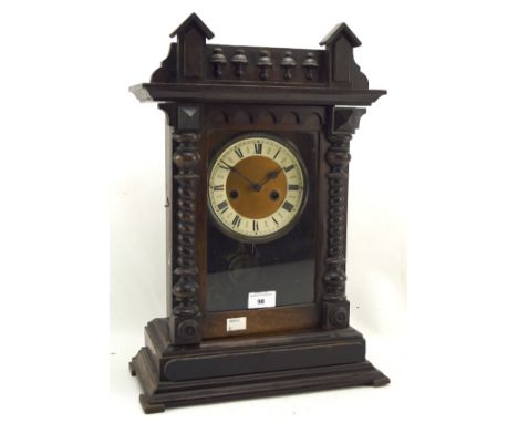 An early 20th century stained mahogany cased mantle clock, the dial with Roman numerals denoting hours, 48cm high