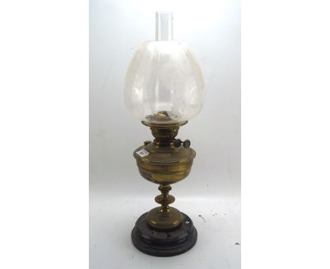 An early 20th century brass oil lamp, British made, with glass shade and funnel, 57cm high