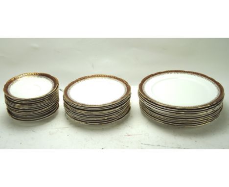 A 20th century Royal Stafford part dinner service, comprising dinner plates, side plates and saucers, each with gilt decorati
