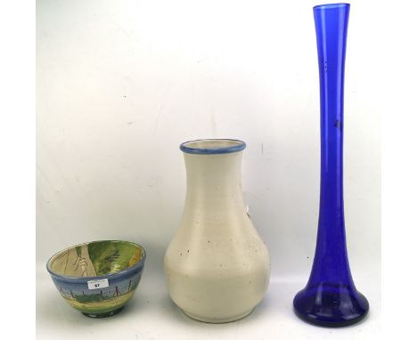 A large glazed ceramic Bourne Denby vase, the white body with blue rim, 35cm high, together with a large blue glass vase and 