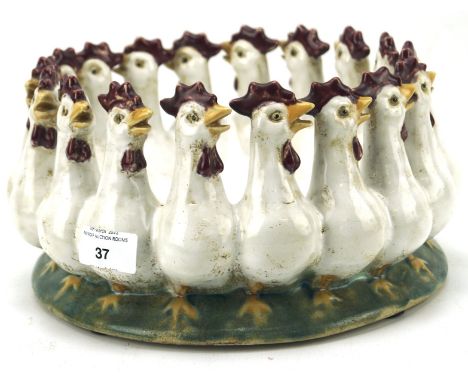 A 20th century ceramic dish modelled as interlocked chickens, indistinct signature to the base, height 14cm