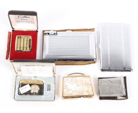 A selection of lighters and cigarette cases, to include a Buler gas lighter with inset clock and more