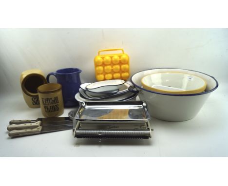 A collection of enamel kitchen wares, including a large basin, a selection of trays, knives, ceramic pots and more