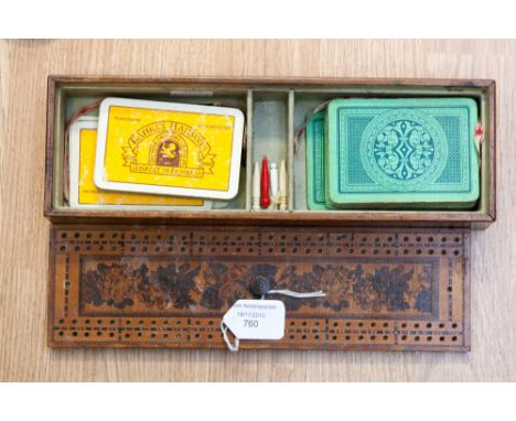 A cribbage board and contents.