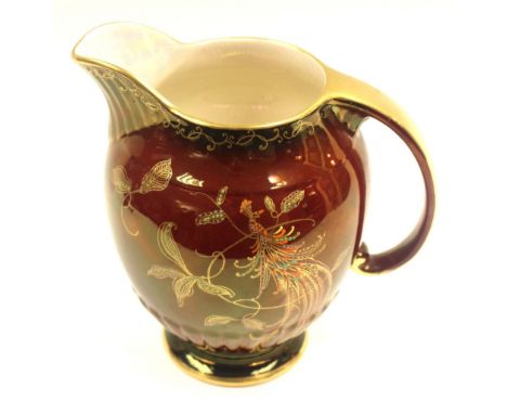 Crown Devon Fieldings, an Art Deco rouge royale lustre jug with bird of paradise design, enamelled and gilded, 22cm high