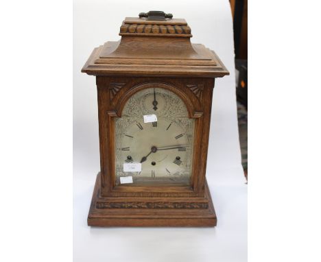 A late 19th Century oak cased bracket clock, patterned dial, caddy top, eight day clock with three winder holes and Westminst