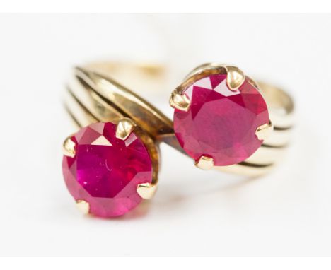 A two stone synthetic ruby ring on 14ct gold band 